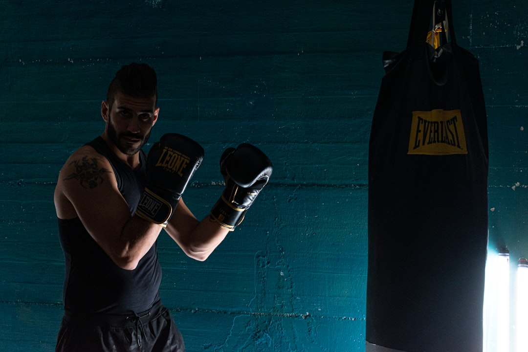 Focused fighter in black boxing gloves preparing mentally before a Muay Thai session
