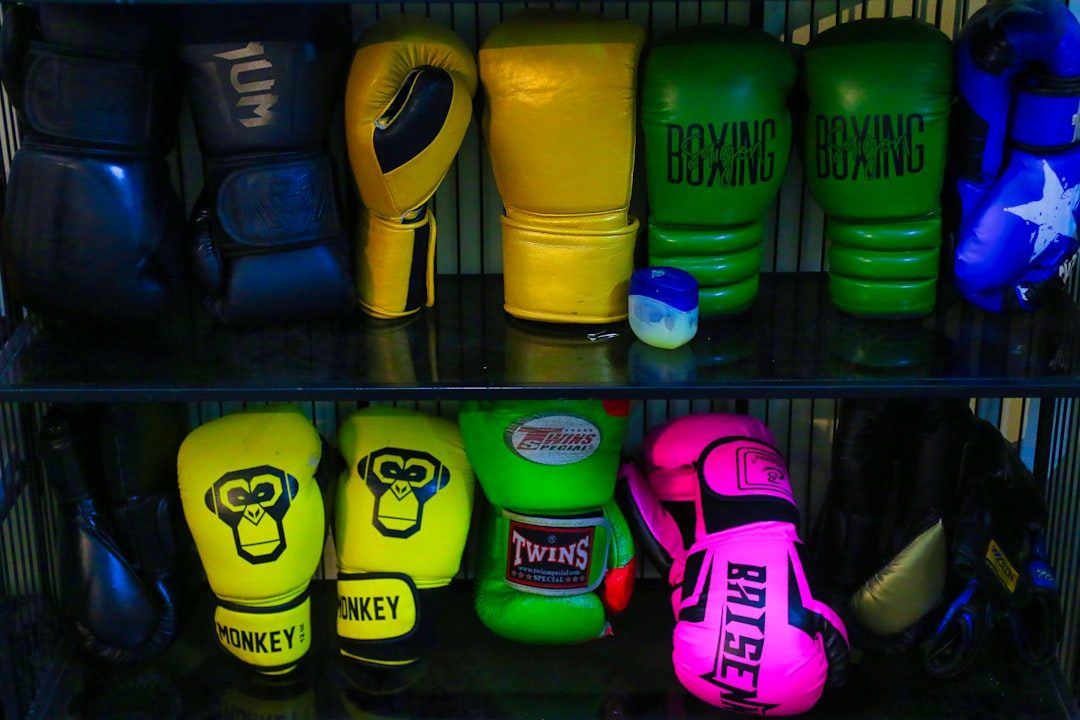Shelf of Muay Thai boxing gloves in multiple colours at a gym equipment store