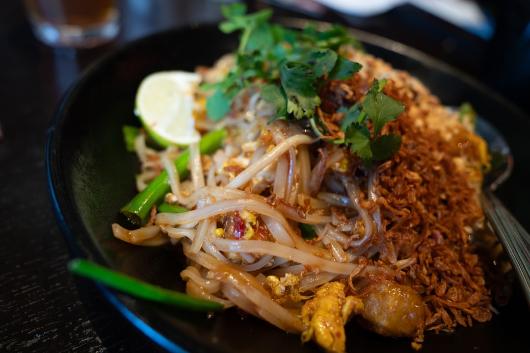 Delicious pad thai with fresh herbs and lime, representing Thai fighter nutrition