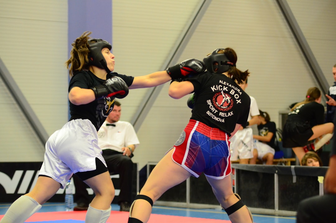 Two women sparring during a kickboxing match.